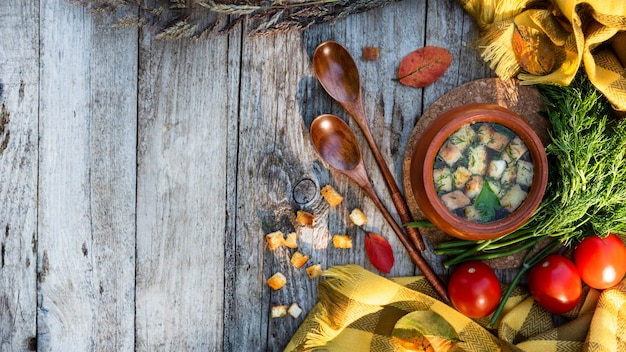 Autumn soup with crackers and herbs