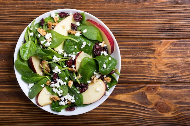 Autumn spinach salad with apple cheese walnut and dried cranberry Healthy vegetarian food