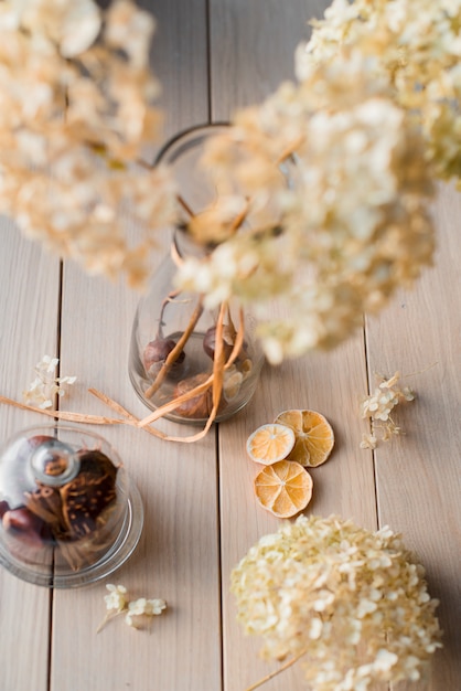 Autumn still life, dry hydrangea and lemon on a wooden background