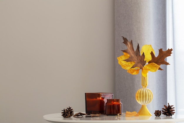 autumn still life with burning candles at home