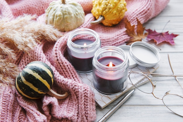 Autumn still life with  pumpkins and burning candles. Cozy fall composition