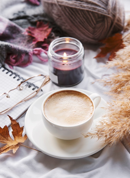 Autumn still life with pumpkins, coffee and burning candles.\
cozy fall composition