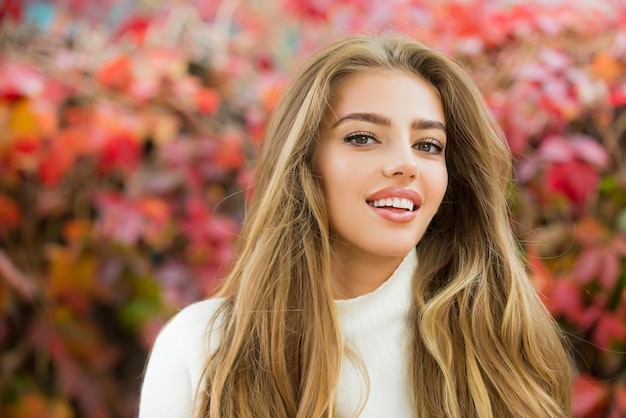 Autumn trend Beautiful woman fashion model having fun in fall park outdoors Happiness carefree