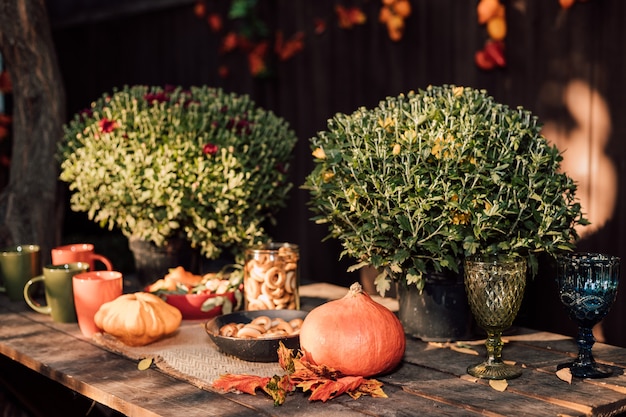 Autumn vegetables and flowers are beautifully laid out on a table in the courtyard