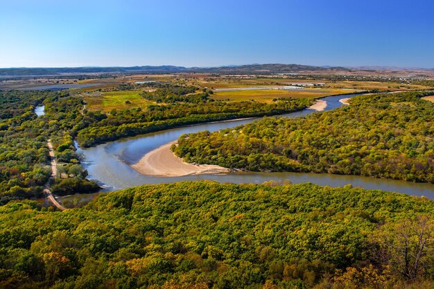 Autumn view from a height of the village and the river