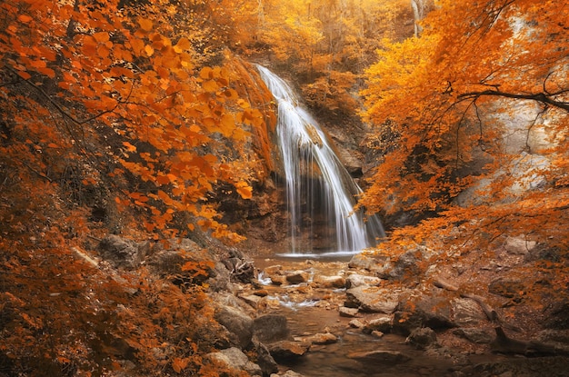 Autumn waterfall and rill flow