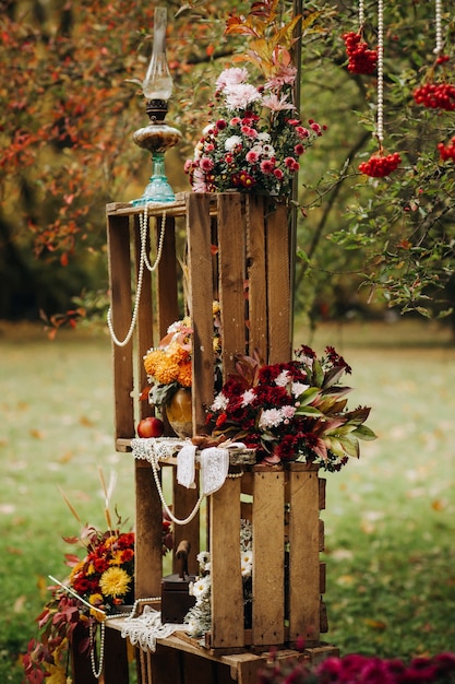 Autumn wedding ceremony on the street on the green lawn.Decor with arches of fresh flowers for the ceremony.