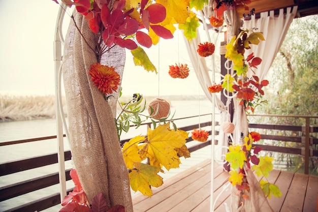 Autumn wedding decor arches in rustic style for the wedding ceremony on the river bank