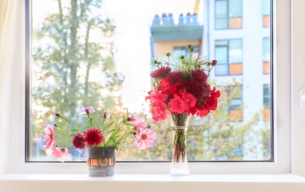 Autumn window Autumn bouquets of flowers cosmea asters geranium in fall