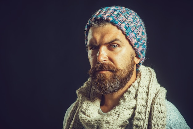 Autumn winter fashion style and people concept attractive bearded man wearing knit hat and scarf on