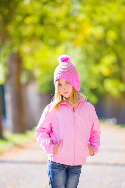 autumn winter kid girl blond with jeans and pink snow cap