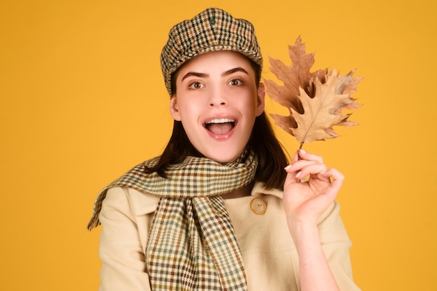 Autumn woman isolated portrait young model with autumn fall leaves in isolated studio background fun