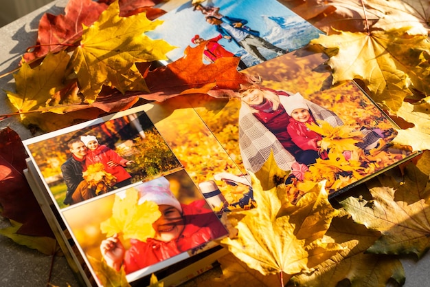 Autumn yellow leaves and family photobook. fall leaves arranged for a photo book background