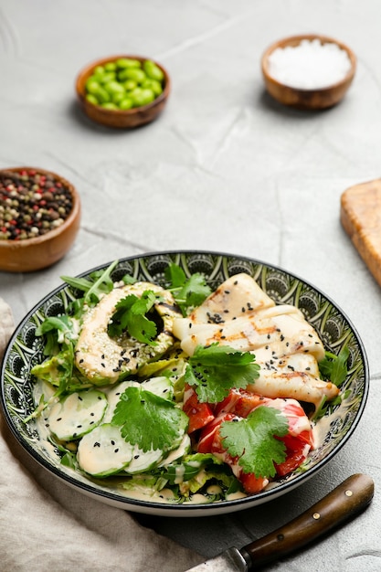 Avacado salad with grilled and fresh vegetables closeup with copy space