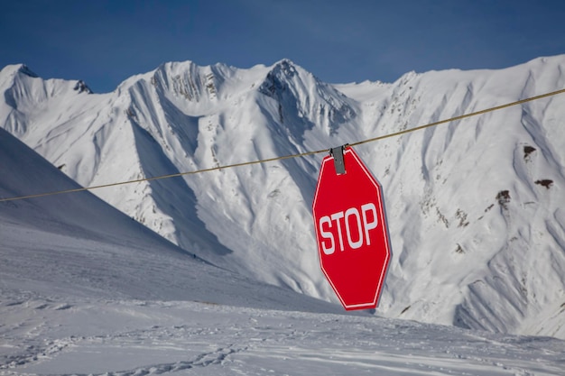 Avalanche danger prohibited zone in high mountains stop sign no passage