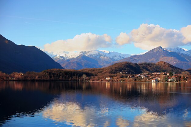 Avigliana town landscape with reflection of sky and mountains in calm lake