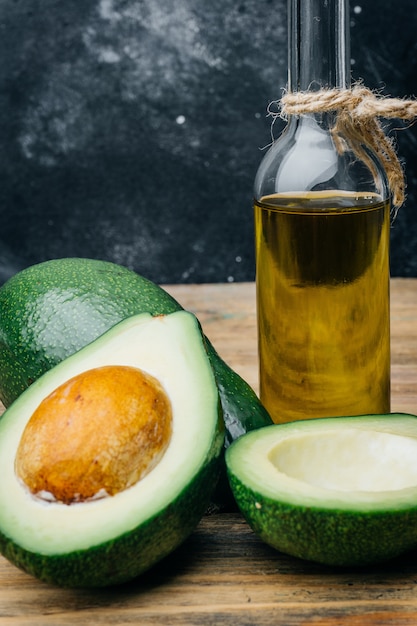 Avocado and avocado oil on a wooden table