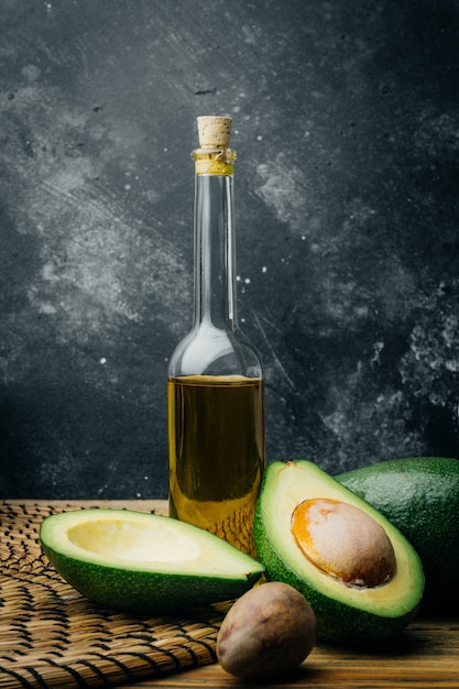 Avocado and avocado oil on a wooden table