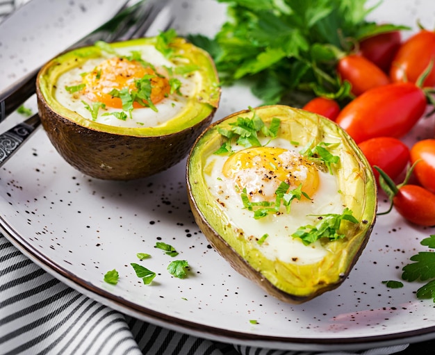 Avocado baked with egg and fresh salad Vegetarian dish Ketogenic diet Keto food