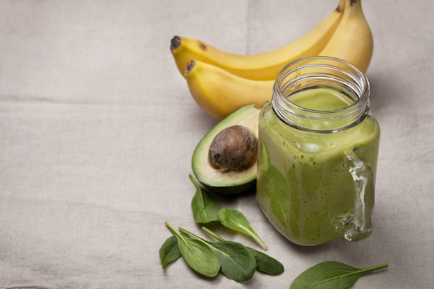 Avocado and banana smoothie in glass jar