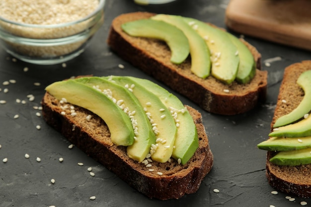 Avocado bread ingredients for making avocado sandwiches On a dark background