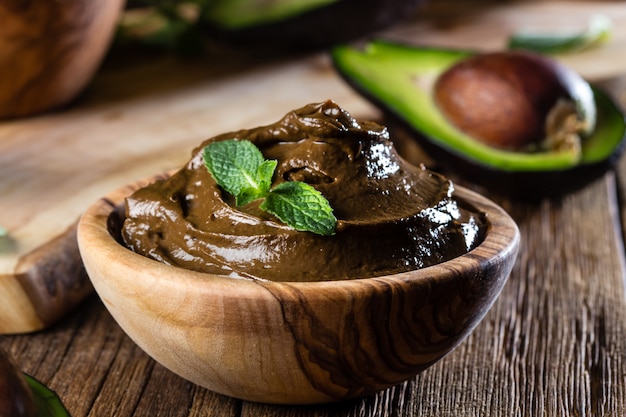 Avocado chocolate mousse in a wooden bowl