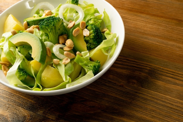 Avocado cucumber broccoli potatoes and peanuts salad