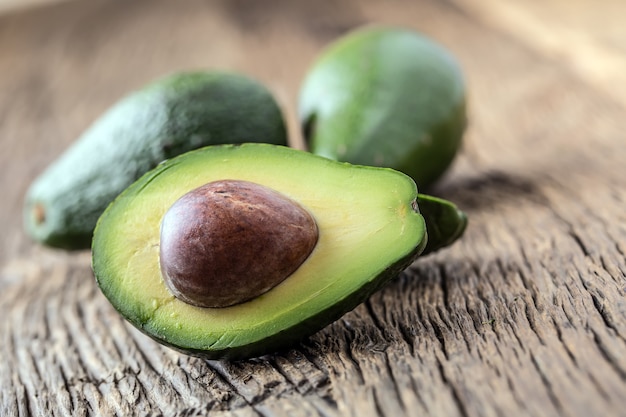 Avocado. Cut avocado on a oak wood background table. Selective focus.