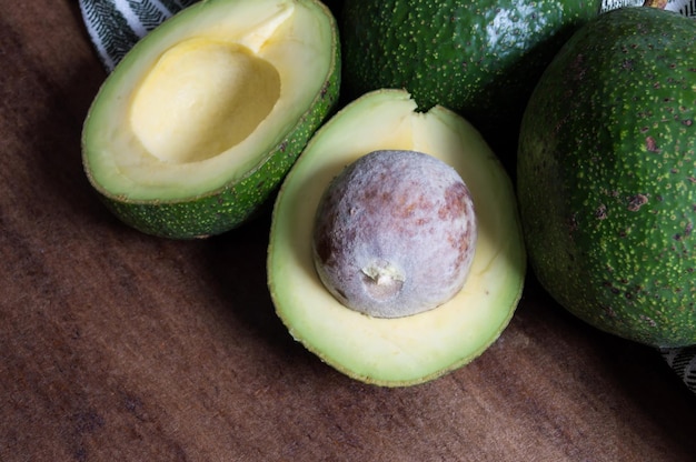 Avocado cut in half on brown table