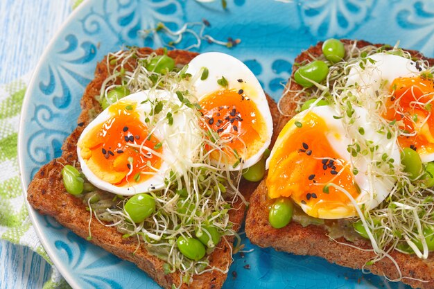 Avocado and egg whole wheat toast with edamame