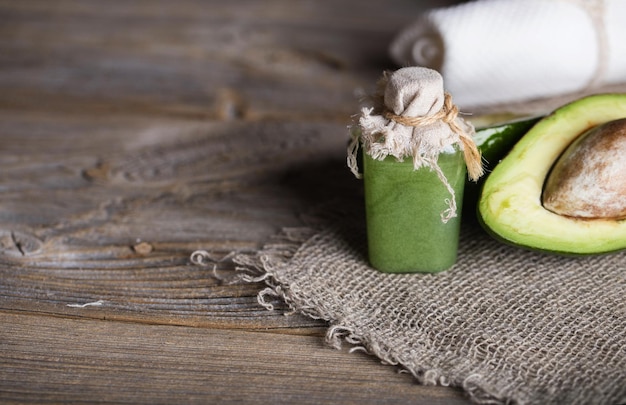 Avocado facial scrub on a wooden surface. closeup