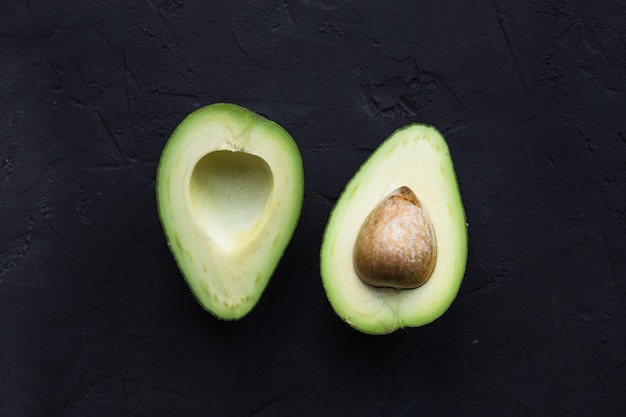 Avocado fruit on a black table