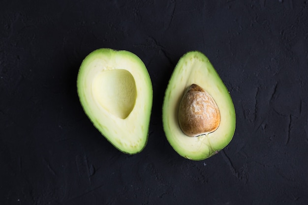 Avocado fruit on a black table