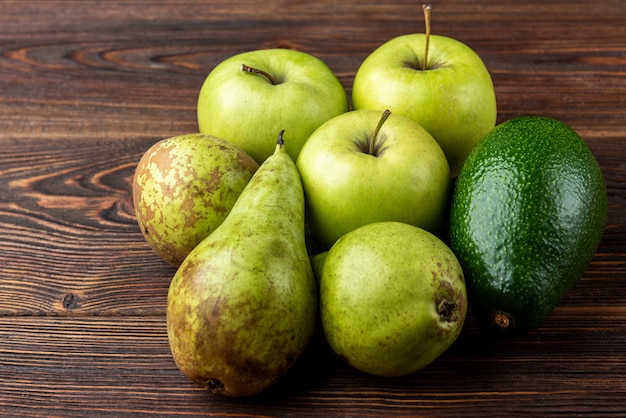 Avocado and green apple on table