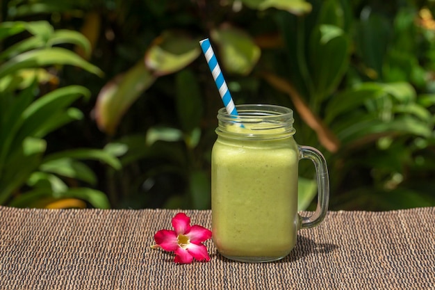 Avocado green shake or smoothie on the table close up Breakfast in island Bali Indonesia