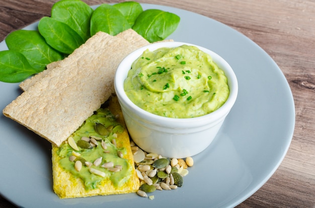 avocado and guacamole on wooden table