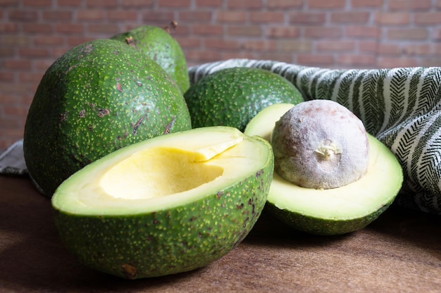 Avocado halves and whole fruit