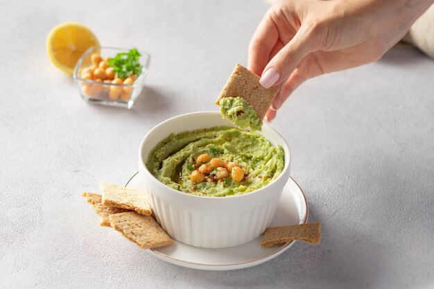 Avocado hummus in bowl with chickpeas