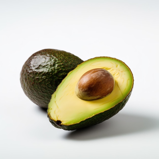 An avocado is cut in half and has the word avocado on the bottom.