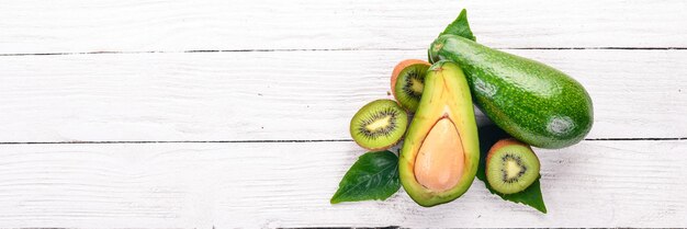 Avocado and kiwi on a wooden background Top view Free space for your text