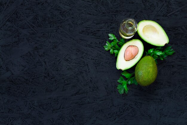 Avocado, lemon parsley, vegetable oil, olive oil, avocado oil
on a black background.