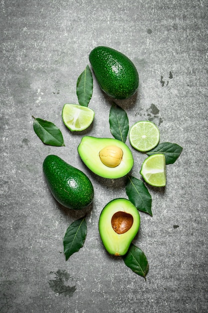 Avocado and lime . On a stone surface.