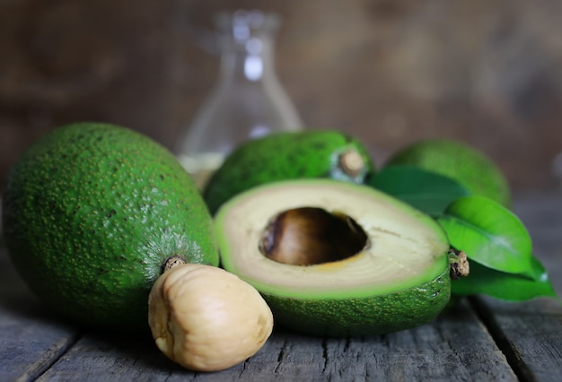 Avocado and oil on wooden background