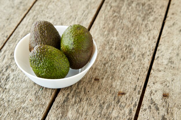 Avocado on old wooden background