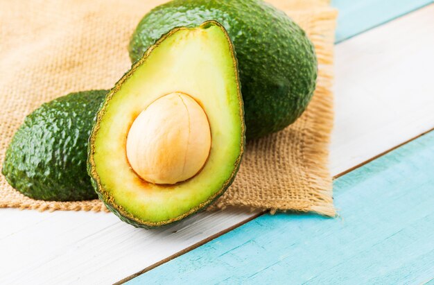 Avocado on old wooden table.