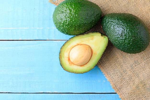 Photo avocado on old wooden table.