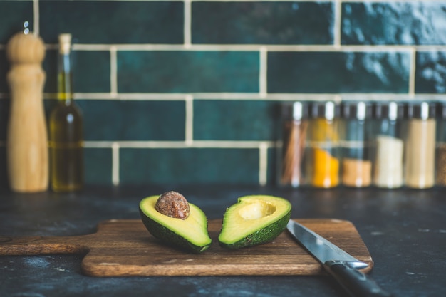 Avocado op de keukentafel. Koken en avocado smoothies in de huiskeuken. Vitaminen en gezond eten concept