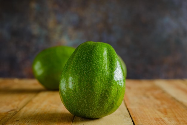 Avocado's op houten tafel. Geïsoleerde avocado's op de voorgrond.