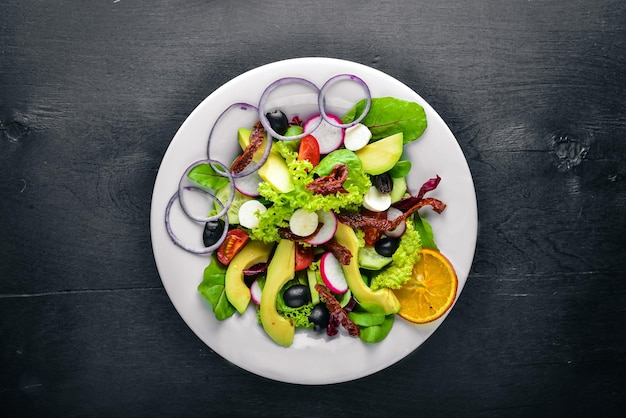 Avocado Salad with grilled meat and greens Italian cuisine Top view On Wooden background