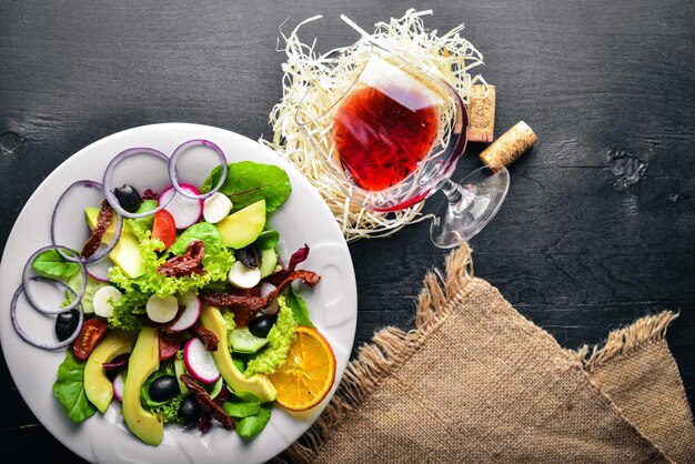 Avocado Salad with grilled meat and greens Italian cuisine Top view On Wooden background